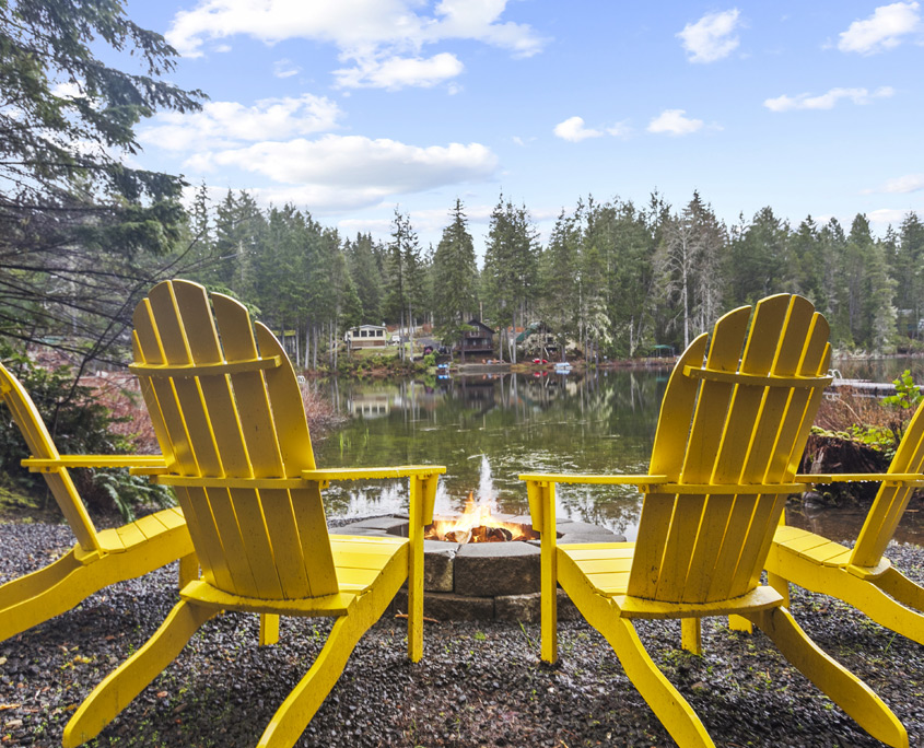 Yellow Adirondack chairs on the lakefront patio