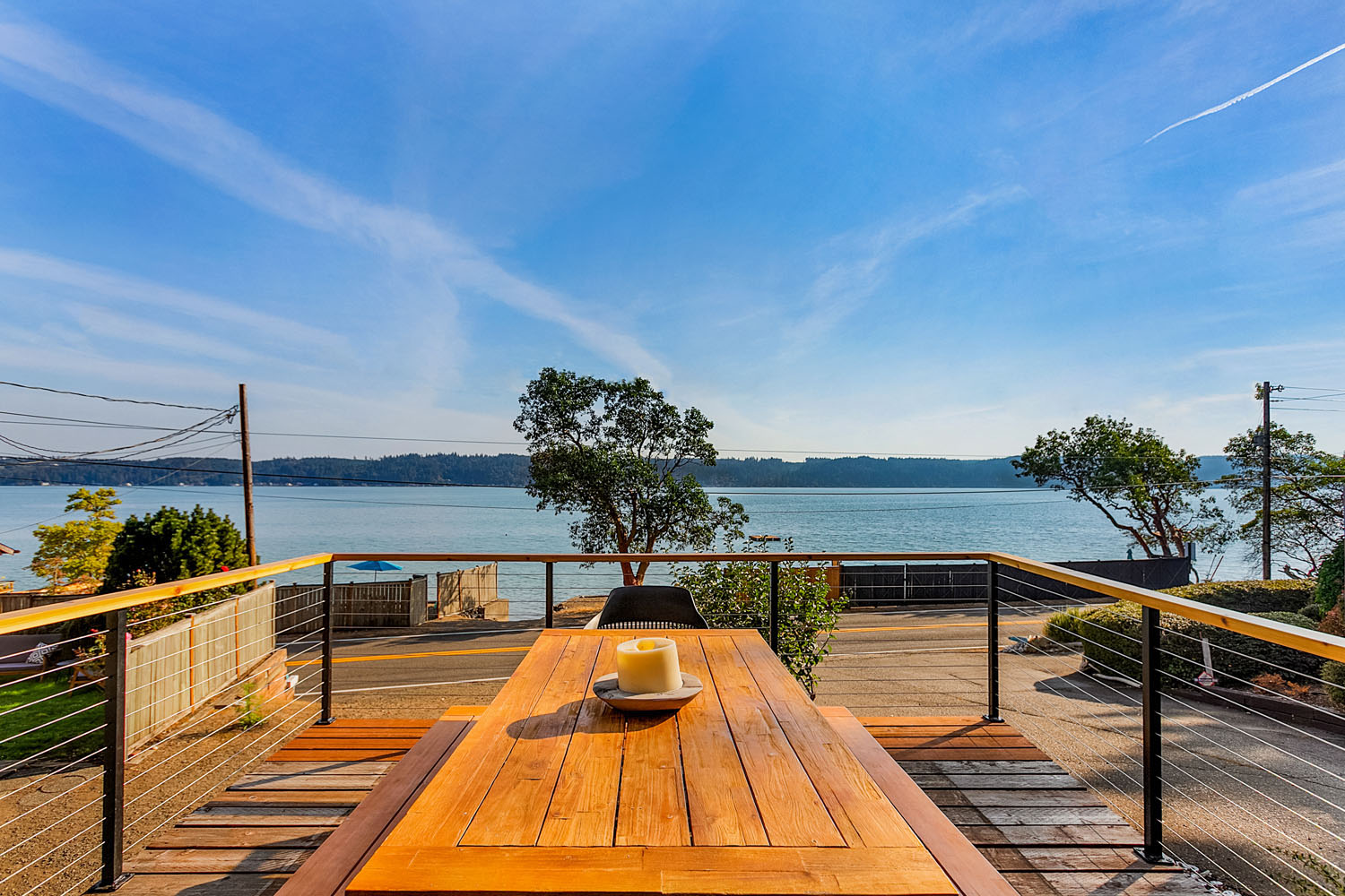 Oversized waterfront deck with outdoor dining and string lights